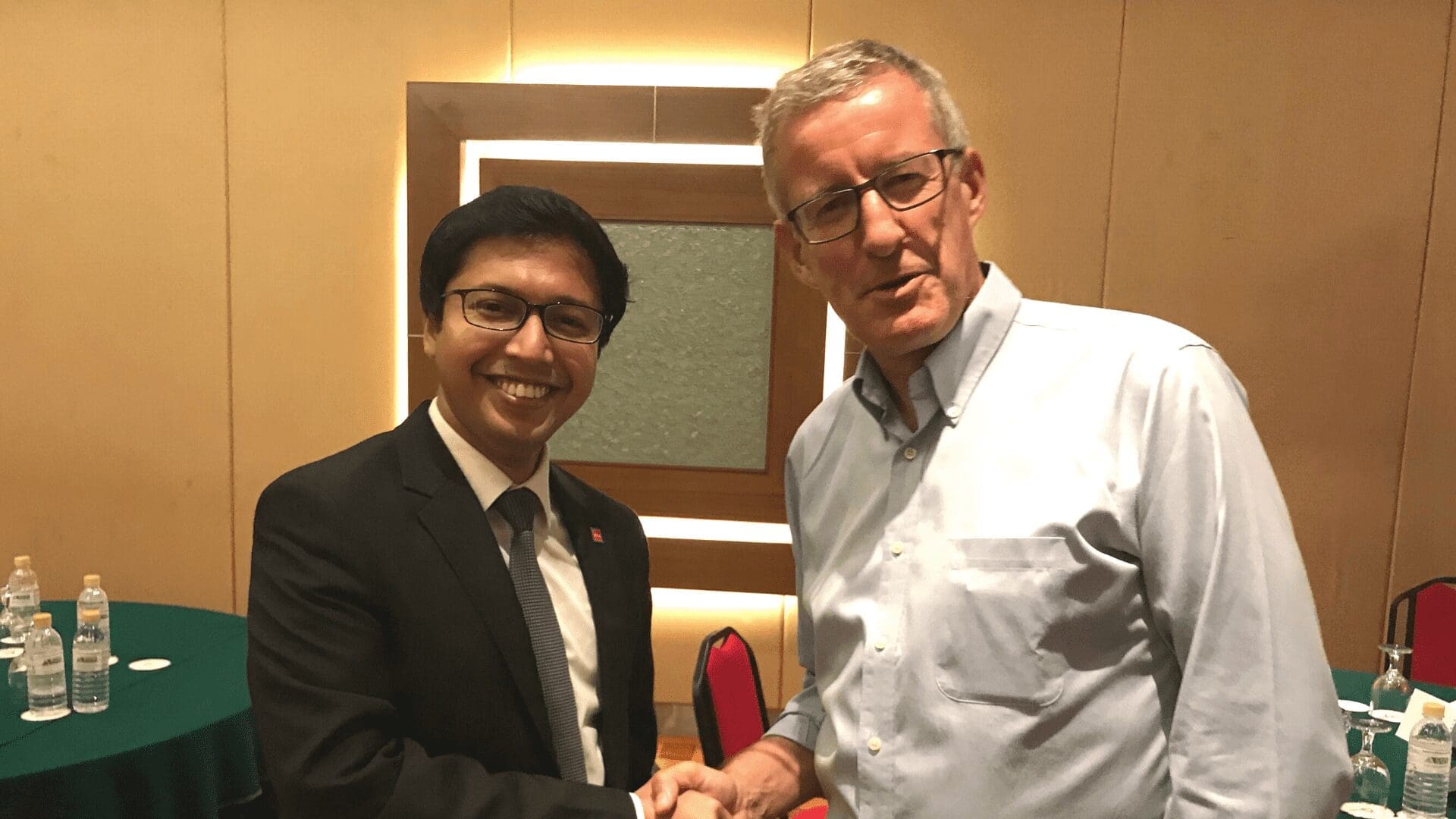 Tom, shaking hands with a former student. 
